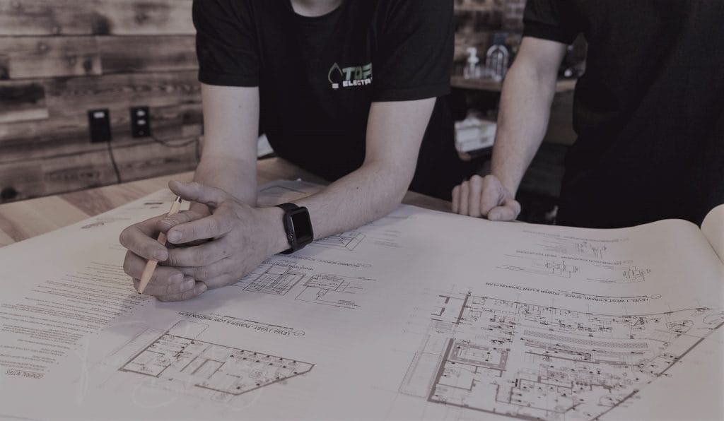 Two people looking at building blueprints.